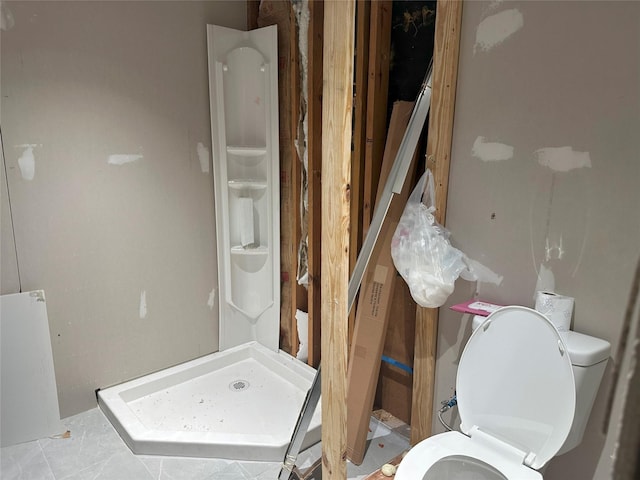 bathroom with tile patterned floors, toilet, and walk in shower