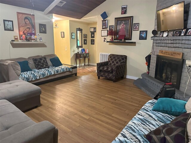 living room featuring wood-type flooring and a fireplace