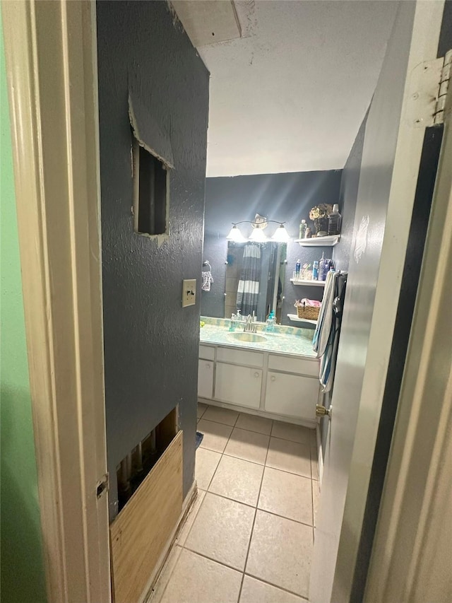 bathroom featuring tile patterned flooring and vanity