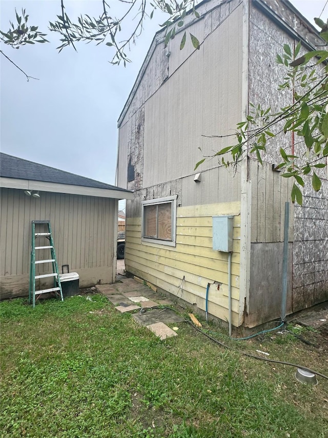 rear view of property with a lawn