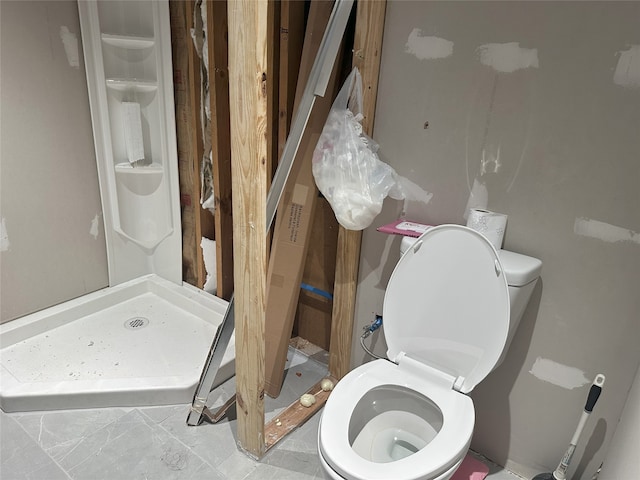 bathroom featuring toilet and a shower