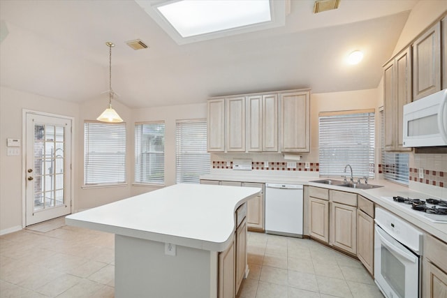 kitchen featuring decorative backsplash, white appliances, sink, a kitchen island, and lofted ceiling