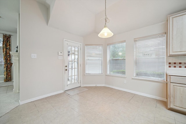 unfurnished dining area with a fireplace and light tile patterned flooring