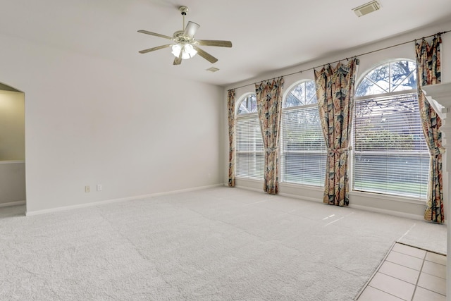 carpeted empty room featuring ceiling fan