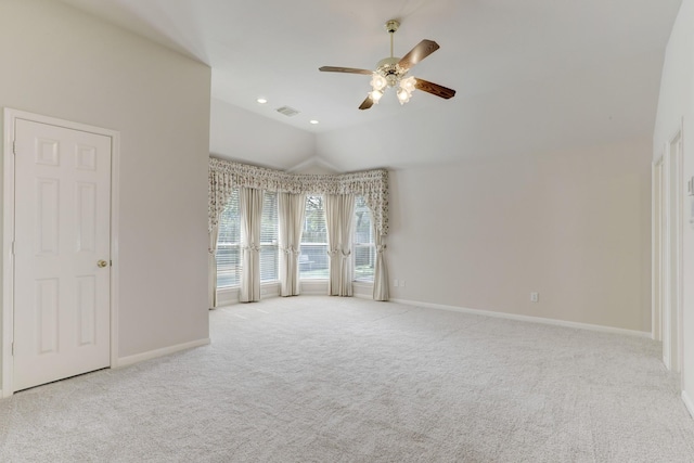 carpeted empty room with vaulted ceiling and ceiling fan