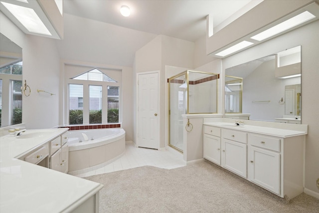 bathroom with vanity, vaulted ceiling, and separate shower and tub