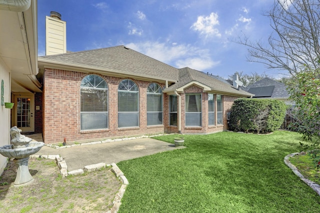 rear view of house featuring a patio area and a yard