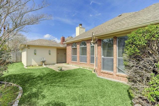 rear view of property featuring a lawn