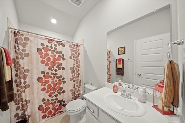 bathroom with vanity, lofted ceiling, and toilet