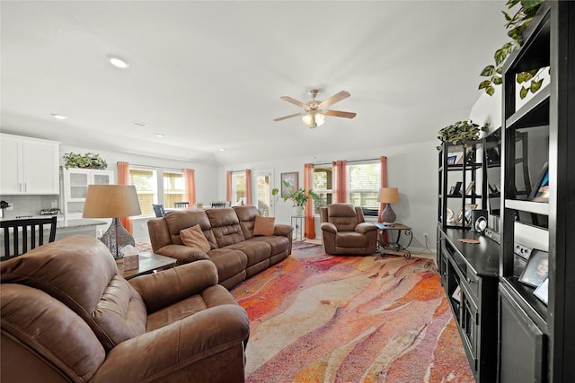 living room with ceiling fan and light carpet