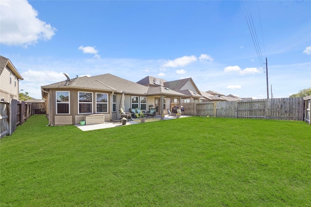 back of property featuring a yard and a patio