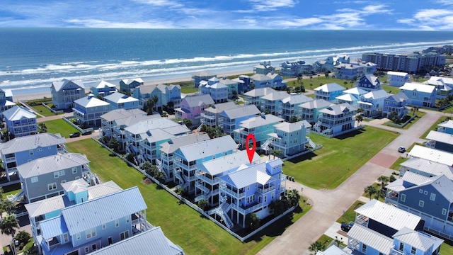 bird's eye view featuring a view of the beach and a water view