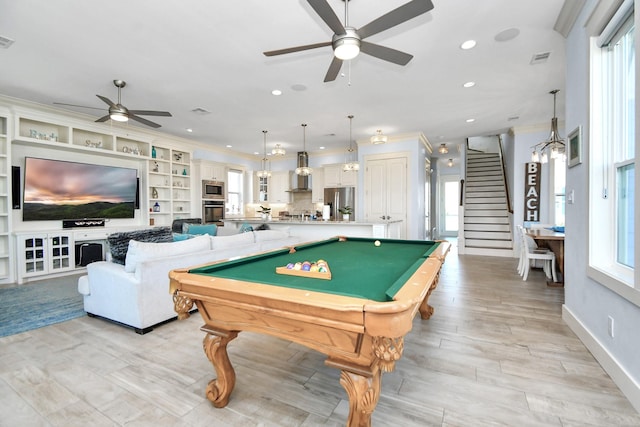 game room featuring plenty of natural light, ceiling fan, built in features, and billiards