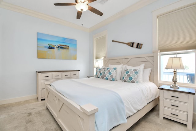 carpeted bedroom with ceiling fan and crown molding