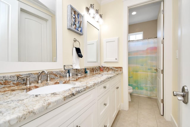 bathroom with tile patterned flooring, vanity, and toilet