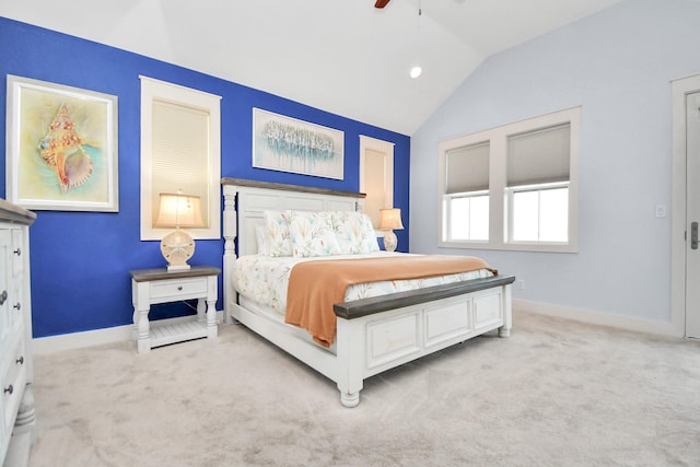 bedroom with ceiling fan, light colored carpet, and vaulted ceiling