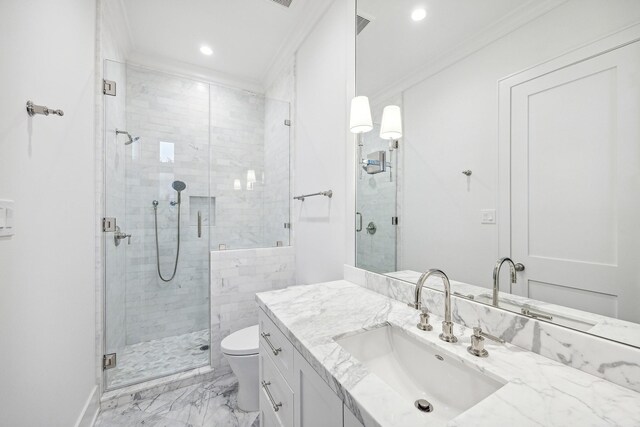 bathroom with a shower with shower door, toilet, ornamental molding, and vanity