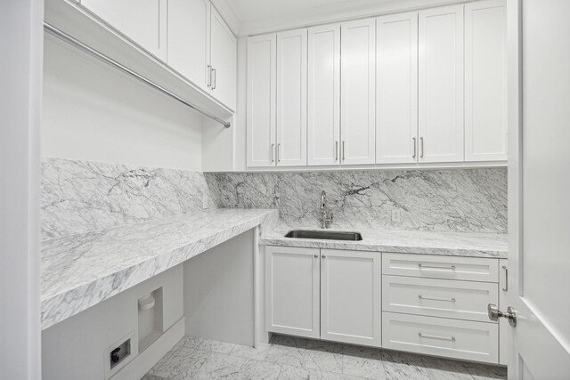 laundry area with sink and cabinets