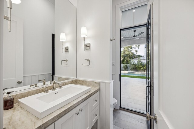 bathroom with vanity, toilet, and wood-type flooring