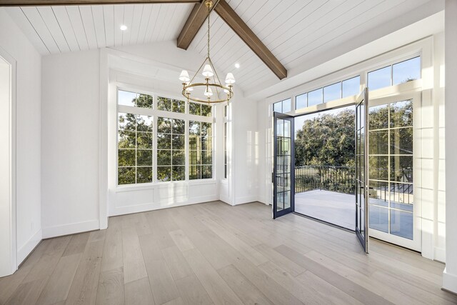 unfurnished dining area featuring a wealth of natural light, light hardwood / wood-style flooring, and a notable chandelier