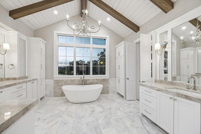 bathroom featuring a tub, vaulted ceiling with beams, and a notable chandelier