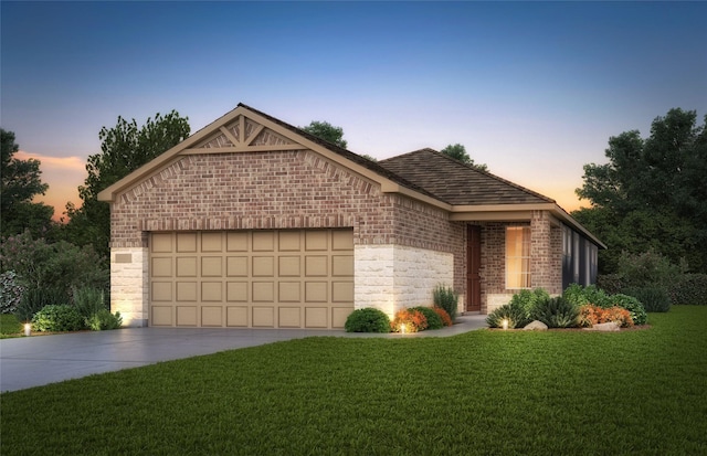 view of front facade with a garage and a lawn