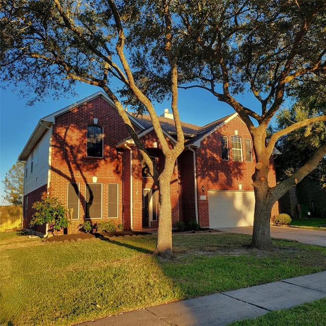 view of front of home featuring a garage and a front yard