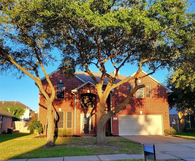 view of front of house with a garage and a front lawn