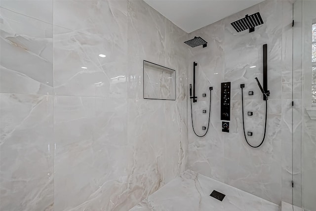 bathroom with tiled shower