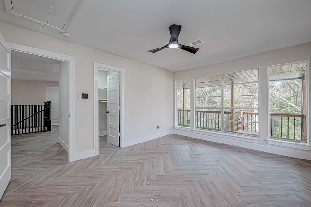 unfurnished sunroom featuring ceiling fan