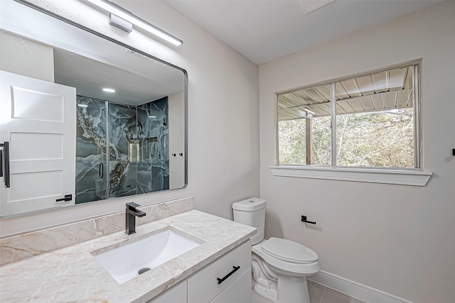 bathroom with tile patterned floors, toilet, vanity, and walk in shower