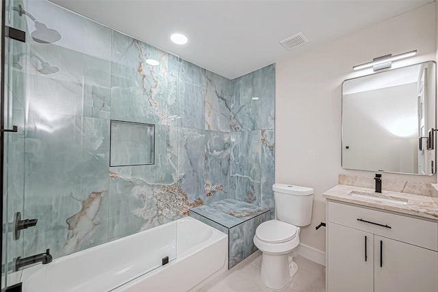 full bathroom with tile patterned flooring, tiled shower / bath combo, toilet, and vanity