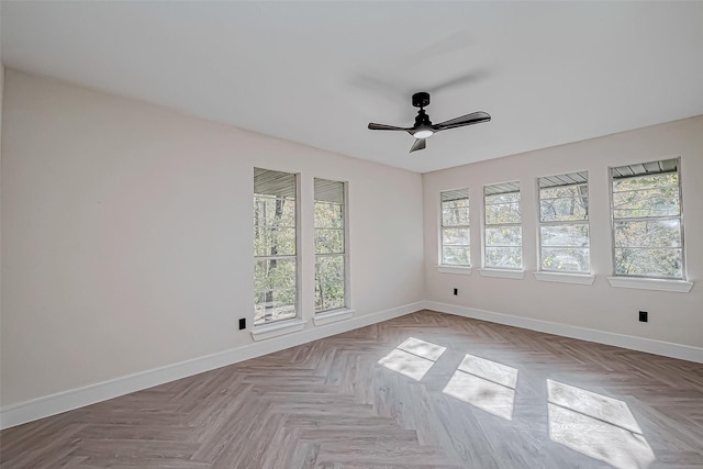 unfurnished room featuring ceiling fan, light parquet floors, and a healthy amount of sunlight