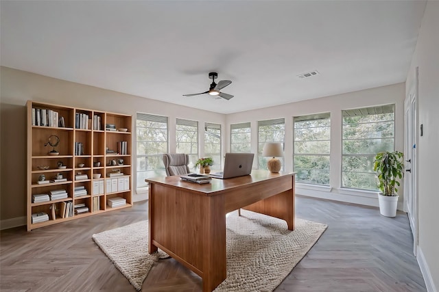 home office with ceiling fan and parquet floors