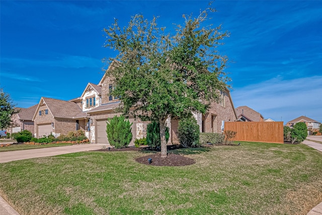 view of front of house featuring a garage and a front yard