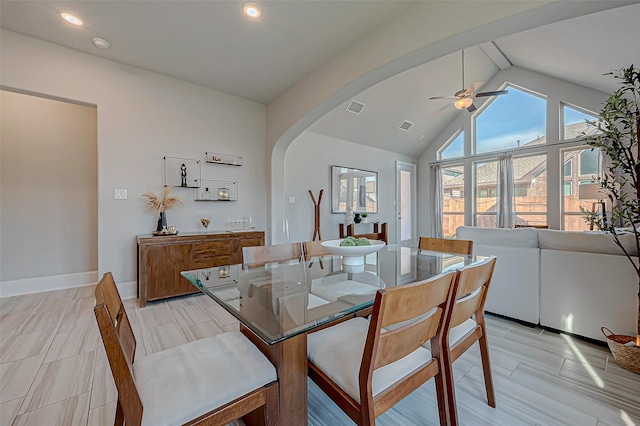 dining room with ceiling fan, high vaulted ceiling, and light hardwood / wood-style floors