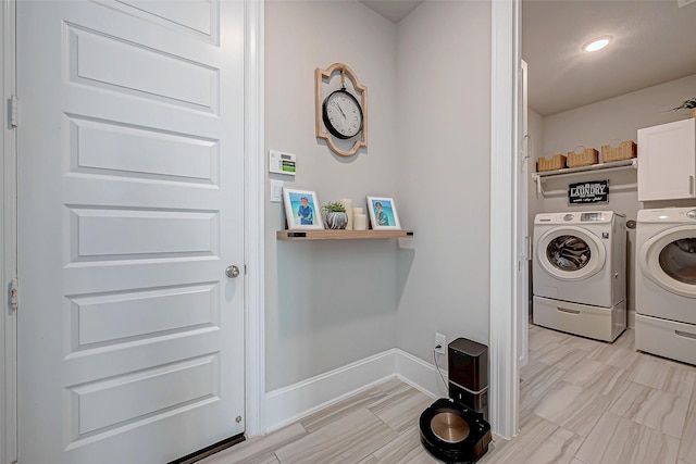 washroom featuring cabinets and independent washer and dryer