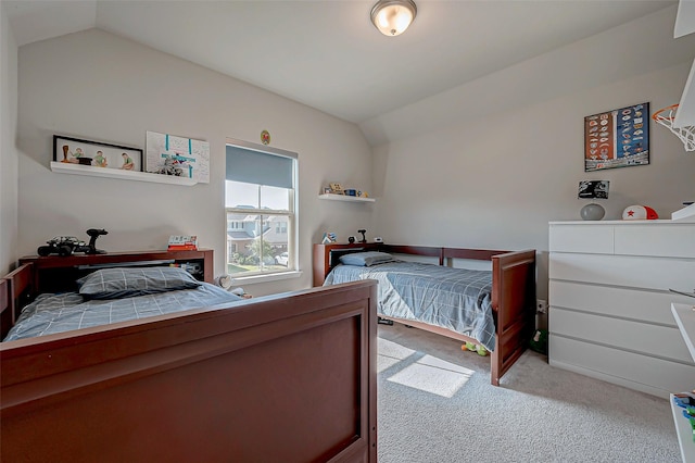 carpeted bedroom with vaulted ceiling