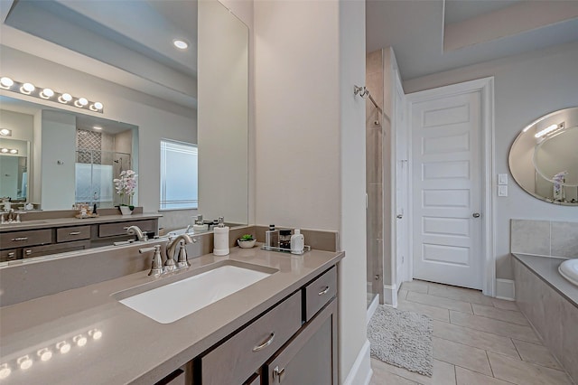 bathroom featuring tile patterned flooring, vanity, and shower with separate bathtub