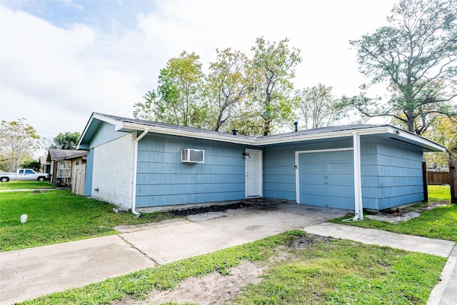 ranch-style home with a front lawn, a wall mounted air conditioner, and a garage