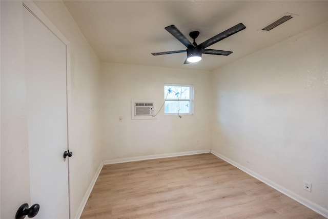 unfurnished room with light hardwood / wood-style floors, a wall mounted AC, and ceiling fan