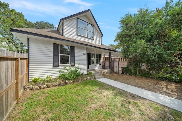 view of front of property with a porch and a front yard