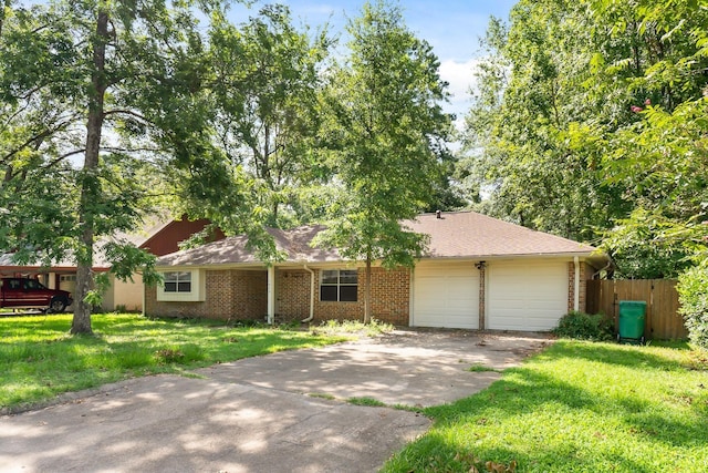 single story home featuring a front yard and a garage