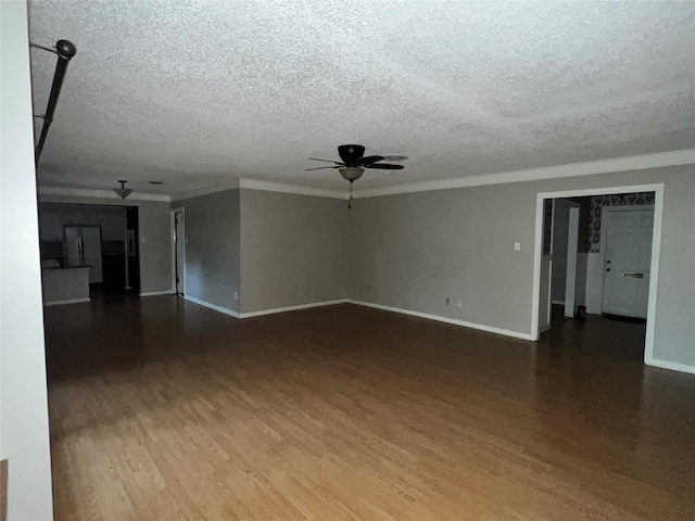 empty room with hardwood / wood-style floors, a textured ceiling, ceiling fan, and crown molding