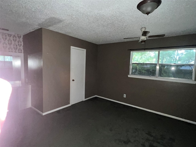 spare room with ceiling fan, carpet floors, and a textured ceiling