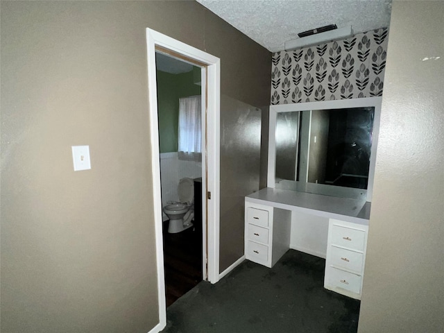 bathroom with a textured ceiling and toilet