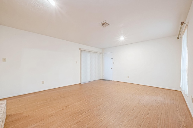 empty room with light hardwood / wood-style flooring