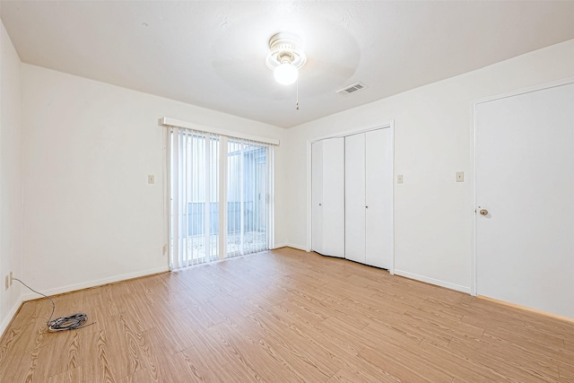 unfurnished bedroom with ceiling fan and light hardwood / wood-style floors