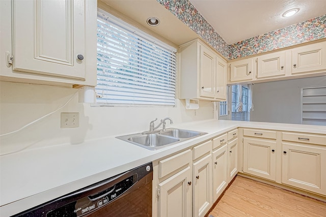 kitchen with dishwasher, light hardwood / wood-style floors, sink, and cream cabinets