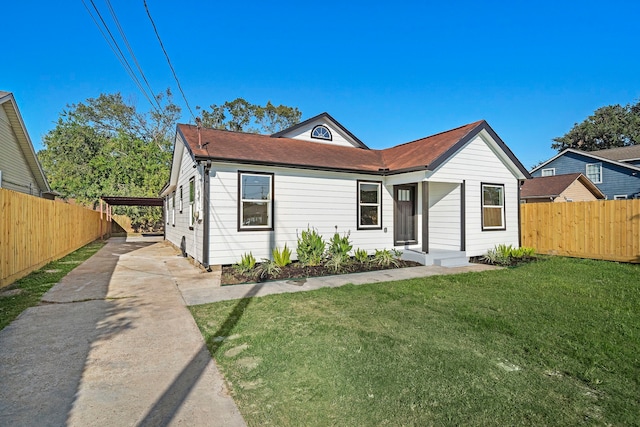 bungalow featuring a front yard and a carport